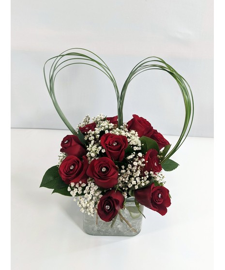 Red rose cube bouquet in quantity of  9 or 12 stems witth diamante pins for shine. 